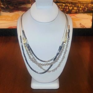 Multiple metallic chains, frosted beaded necklace.